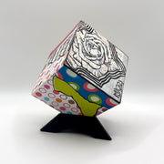 3-D CUBE ART #12 by Mary-Jo Lough, hand-painted 2.25” cube made from solid wood, featuring vibrant abstract art and layered details on a triangle stand.