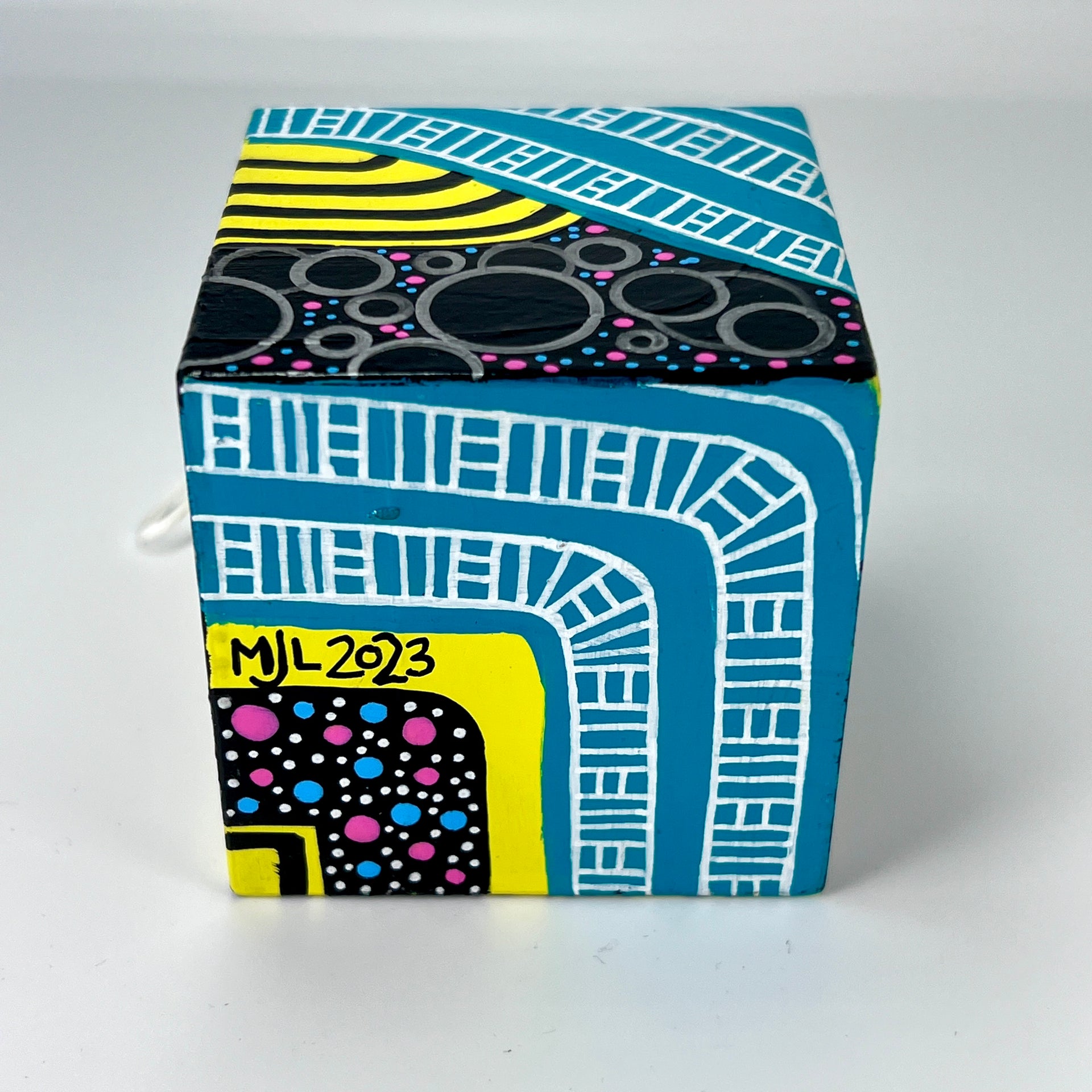 3-D CUBE ART #16 by Mary-Jo Lough, hand-painted 2.25” cube made from solid wood, featuring vibrant abstract art and layered details.