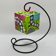 3-D CUBE ART #19 by Mary-Jo Lough, hand-painted 2.25” cube made from solid wood, featuring vibrant abstract art and layered details on a hanging stand.