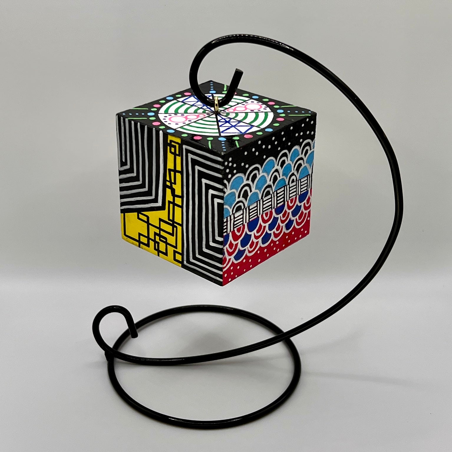 3-D CUBE ART #20 by Mary-Jo Lough, hand-painted 2.25” cube made from solid wood, featuring vibrant abstract art and layered details on a hanging stand.