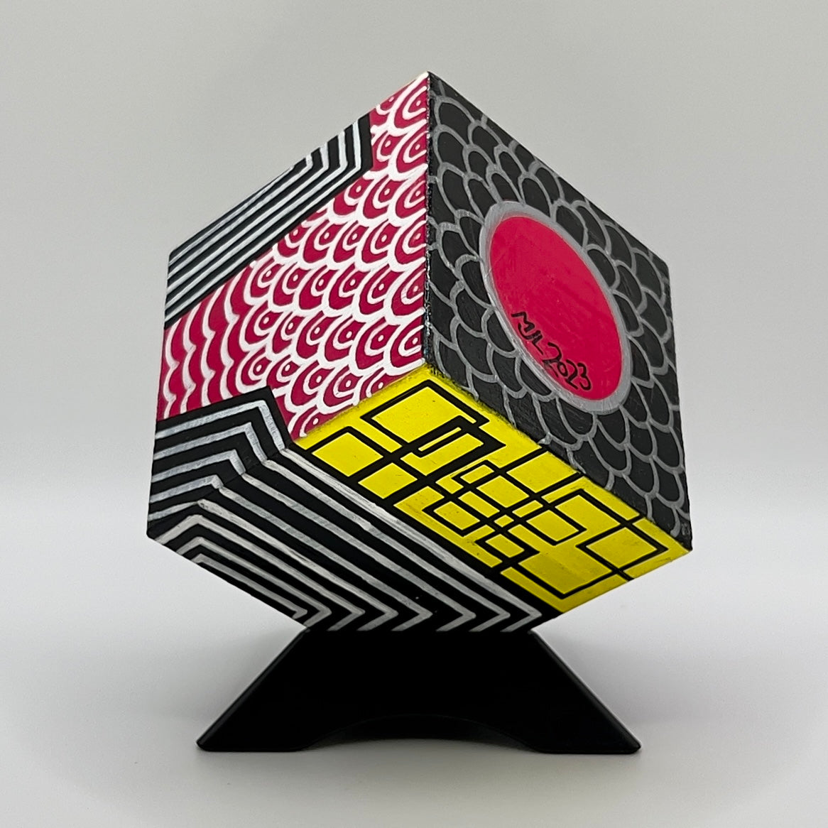 3-D CUBE ART #20 by Mary-Jo Lough, hand-painted 2.25” cube made from solid wood, featuring vibrant abstract art and layered details on a triangle stand.