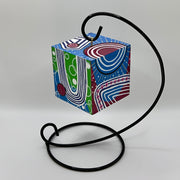 3-D CUBE ART #24 by Mary-Jo Lough, hand-painted 2.25” cube made from solid wood, featuring vibrant abstract art and layered details on a hanging stand.