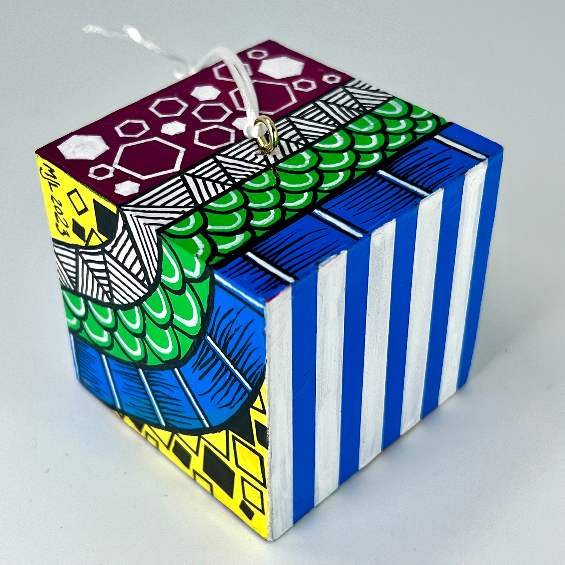 3-D CUBE ART #28 by Mary-Jo Lough, hand-painted 2.25” cube made from solid wood, featuring vibrant abstract art and layered details.