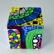 3-D CUBE ART #28 by Mary-Jo Lough, hand-painted 2.25” cube made from solid wood, featuring vibrant abstract art and layered details.