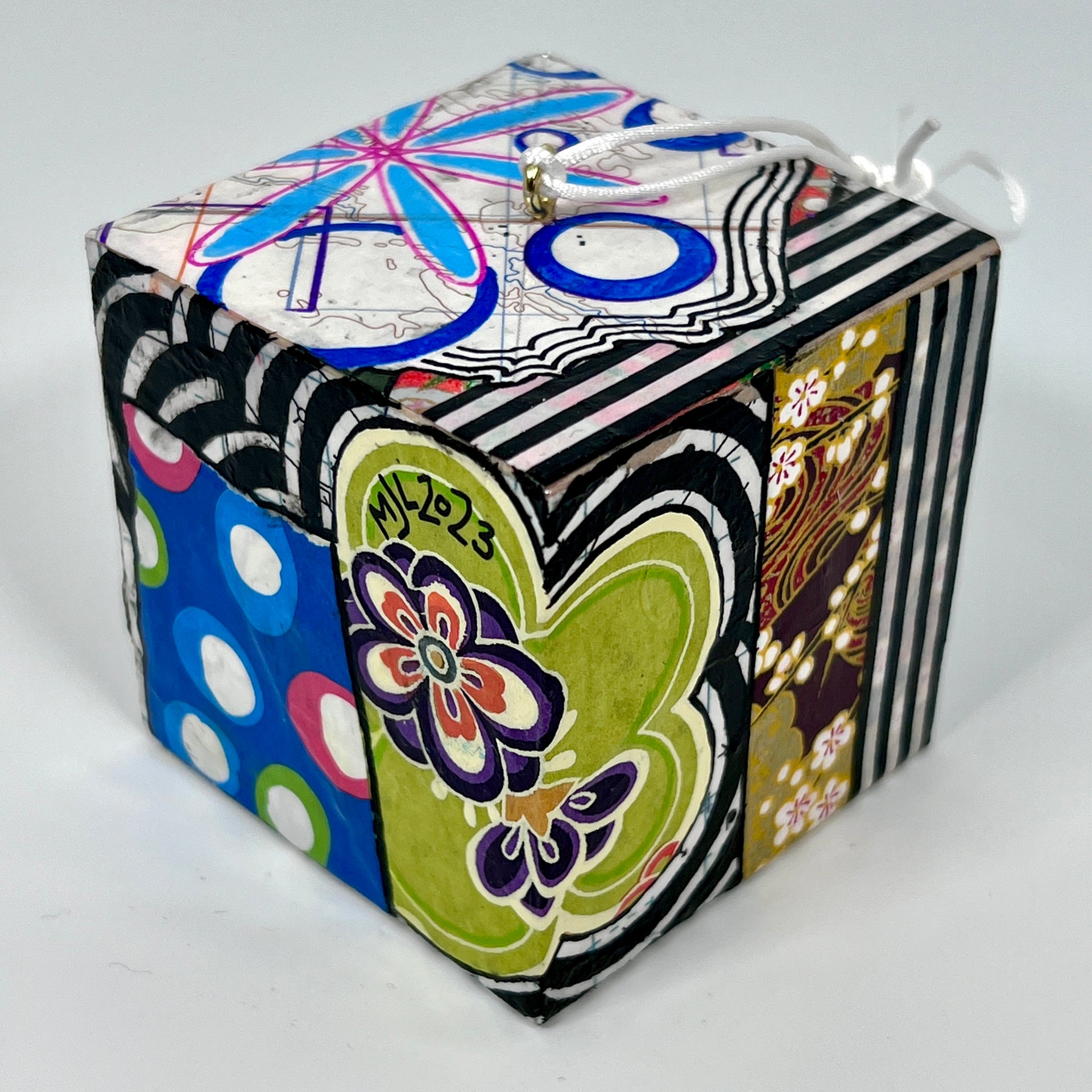 3-D CUBE ART #7 by Mary-Jo Lough, hand-painted 2.25” cube made from solid wood, featuring vibrant abstract art and layered details.